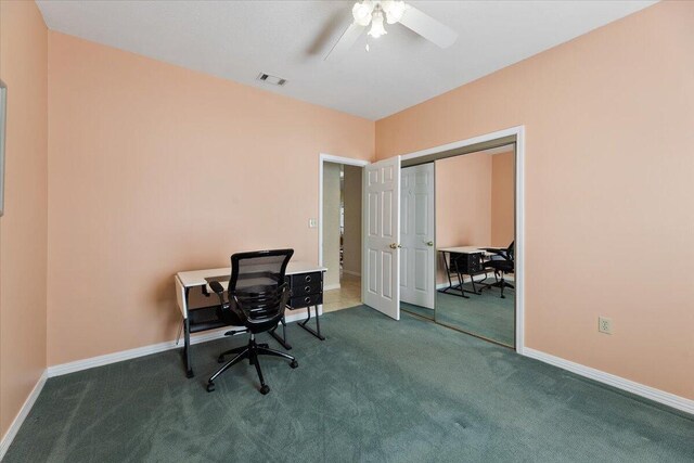 carpeted office featuring ceiling fan