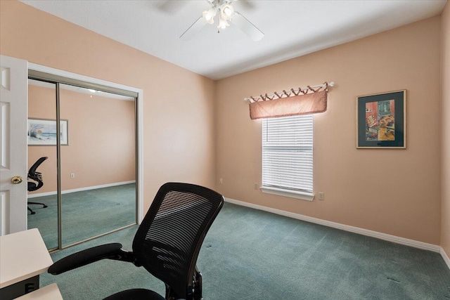 carpeted home office featuring ceiling fan