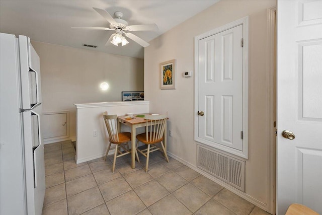 tiled dining room featuring ceiling fan