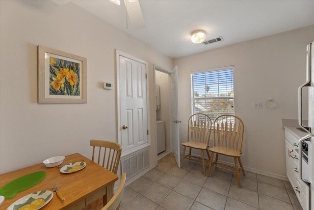 dining space with light tile patterned flooring and ceiling fan