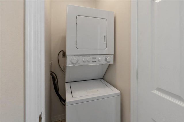 laundry area with stacked washer and clothes dryer