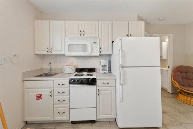 kitchen with white cabinets, white appliances, sink, and light tile patterned flooring