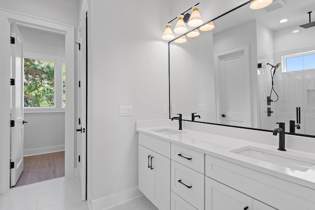 bathroom with vanity, tile patterned flooring, and a shower with shower door