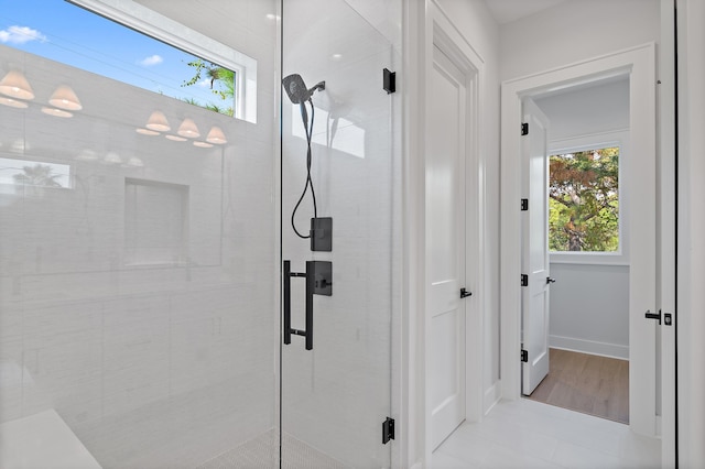 bathroom featuring walk in shower and hardwood / wood-style floors