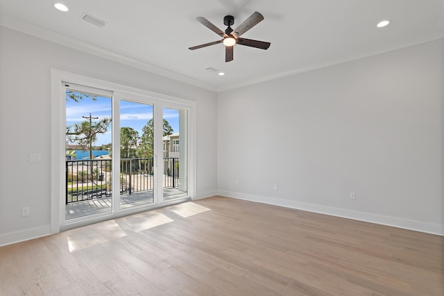 spare room with light hardwood / wood-style floors, ceiling fan, and ornamental molding