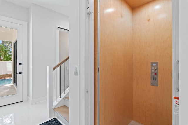 interior space featuring elevator and tile patterned floors