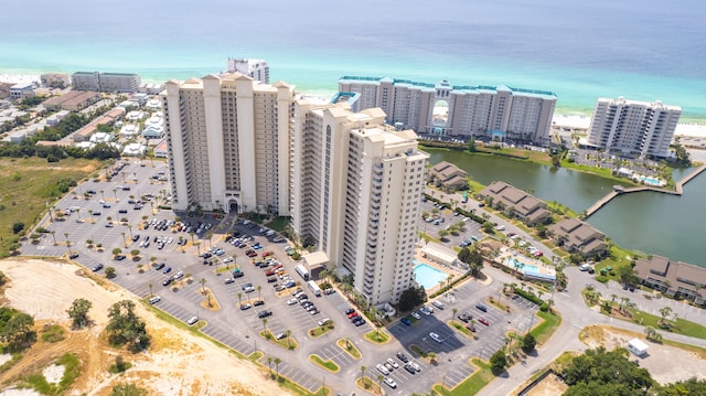 birds eye view of property with a water view and a beach view