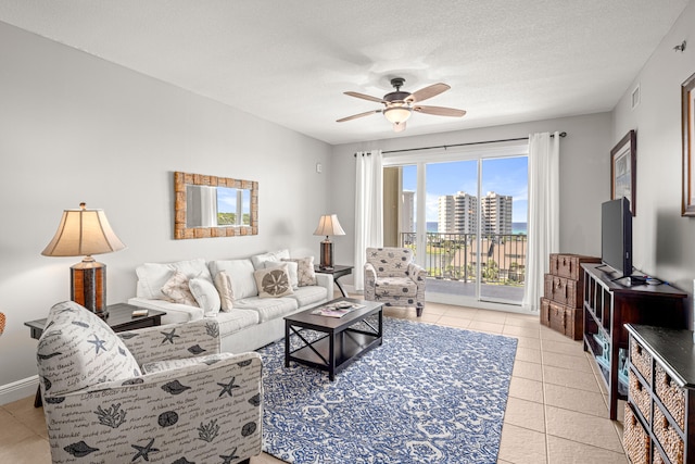 tiled living room with a textured ceiling and ceiling fan