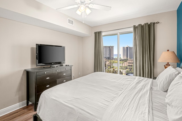 bedroom with hardwood / wood-style flooring, access to exterior, and ceiling fan