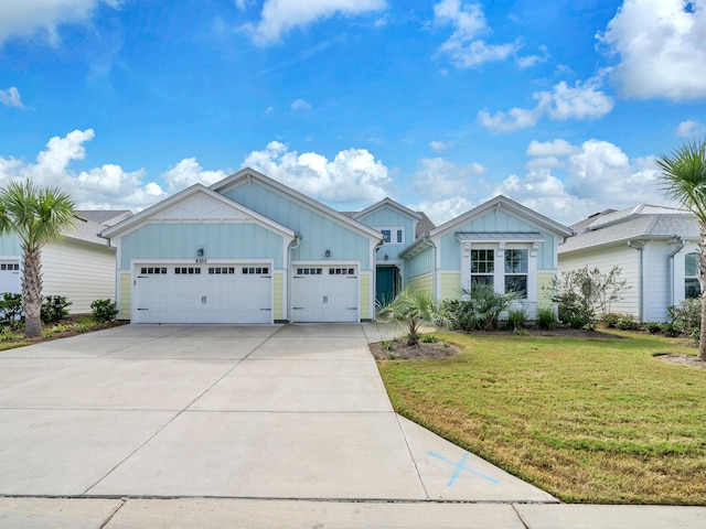 view of front of home with a garage and a front lawn