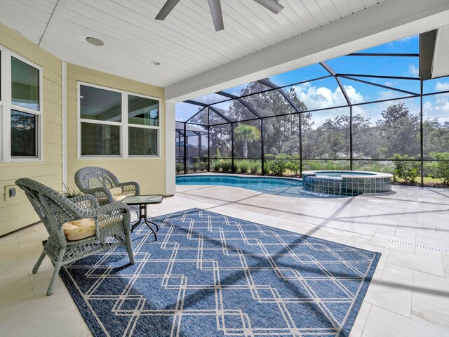 view of patio / terrace with ceiling fan, a lanai, and a pool with hot tub