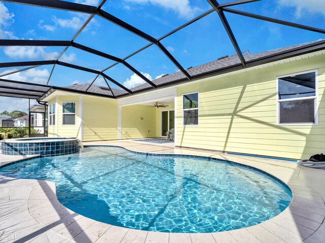 view of pool with a patio area, a lanai, ceiling fan, and an in ground hot tub