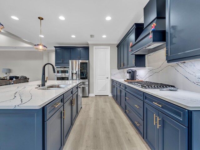 kitchen with stainless steel appliances, backsplash, decorative light fixtures, blue cabinets, and light hardwood / wood-style flooring