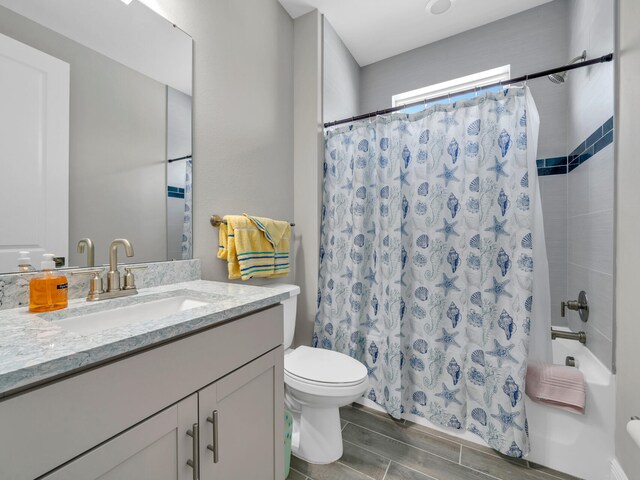 full bathroom with vanity, toilet, and shower / tub combo with curtain