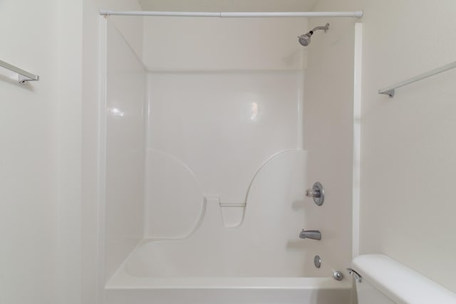 bathroom with shower / bath combination and toilet