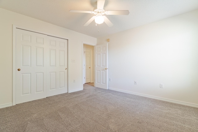 unfurnished bedroom featuring carpet, ceiling fan, and a closet