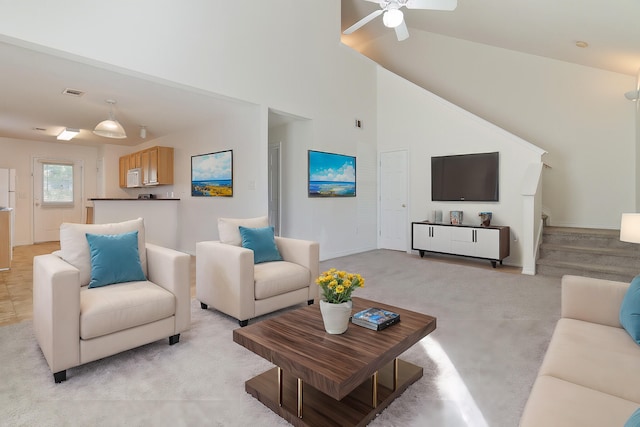 living room with lofted ceiling, light colored carpet, and ceiling fan