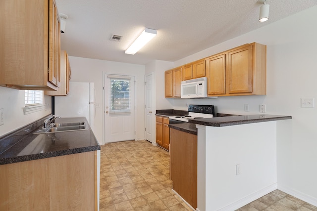 kitchen featuring sink, range with electric cooktop, kitchen peninsula, and a textured ceiling