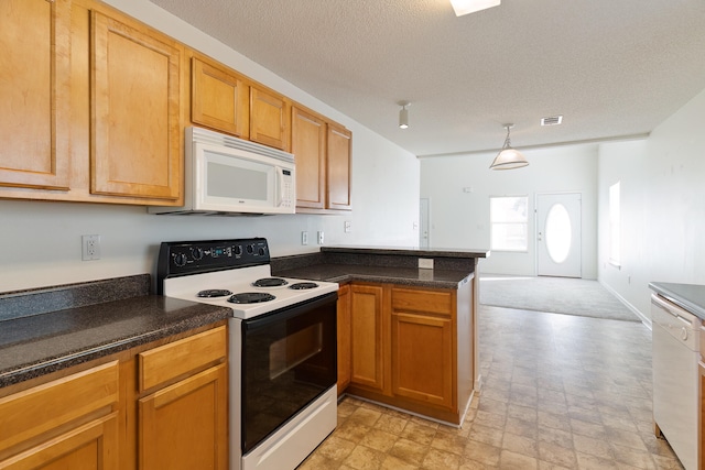 kitchen with white appliances, kitchen peninsula, hanging light fixtures, and a textured ceiling