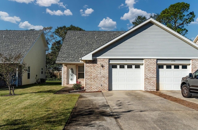 view of front of property with a garage, central AC, and a front yard