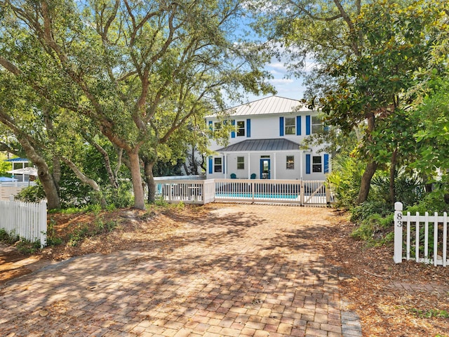 rear view of property featuring a pool