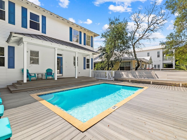 view of swimming pool featuring a deck