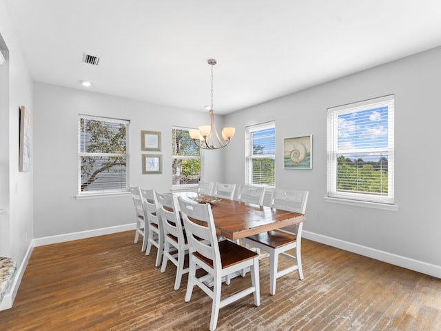 dining room featuring a notable chandelier and dark hardwood / wood-style floors