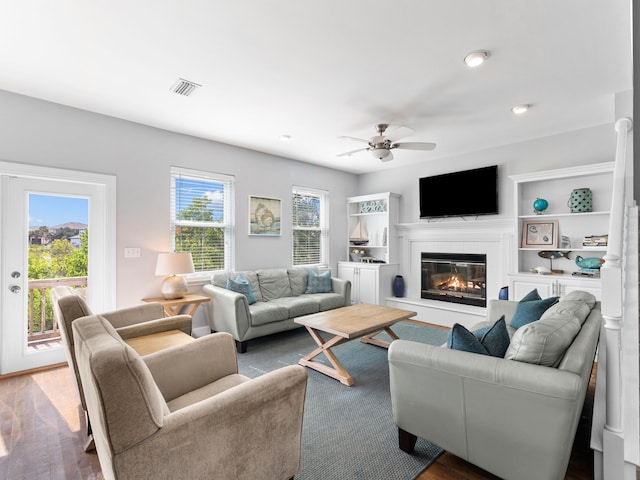 living room featuring wood-type flooring and ceiling fan