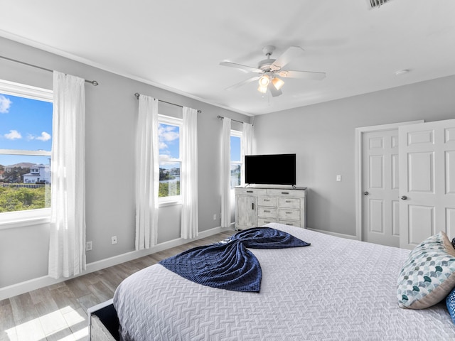 bedroom featuring light hardwood / wood-style floors and ceiling fan