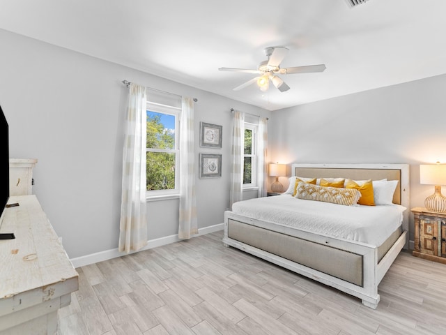 bedroom with ceiling fan and light hardwood / wood-style flooring