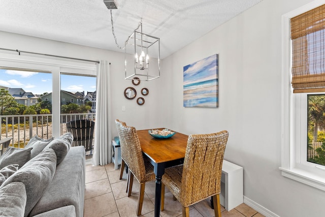 11 Beachside Dr Unit 1121, Santa Rosa Beach, FL 32459 - dining area featuring plenty of natural light, light tile patterned floors, a chandelier, and a textured ceiling