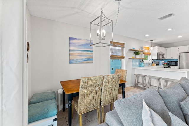 11 Beachside Dr Unit 1121, Santa Rosa Beach, FL 32459 - dining area featuring a chandelier, light tile patterned floors, recessed lighting, and a textured ceiling