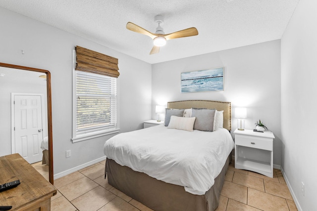 bedroom featuring ceiling fan, a textured ceiling, and light tile patterned floors