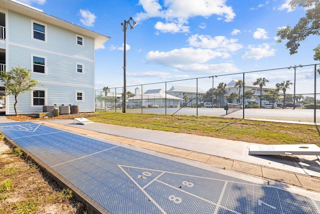 view of community featuring tennis court