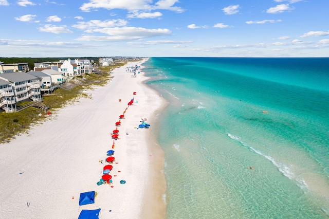 drone / aerial view with a beach view and a water view