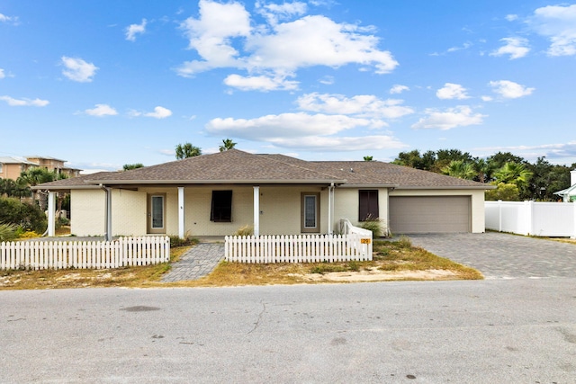 single story home featuring a garage and covered porch