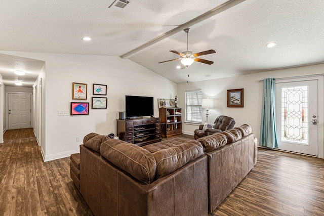 living room with a textured ceiling, dark wood-type flooring, vaulted ceiling with beams, and ceiling fan