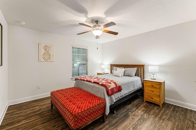 bedroom featuring dark wood-type flooring, ceiling fan, and a textured ceiling