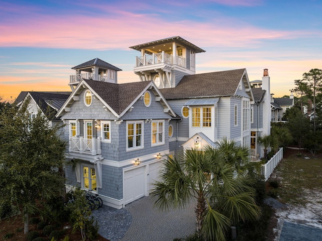 view of front facade with a garage and a balcony