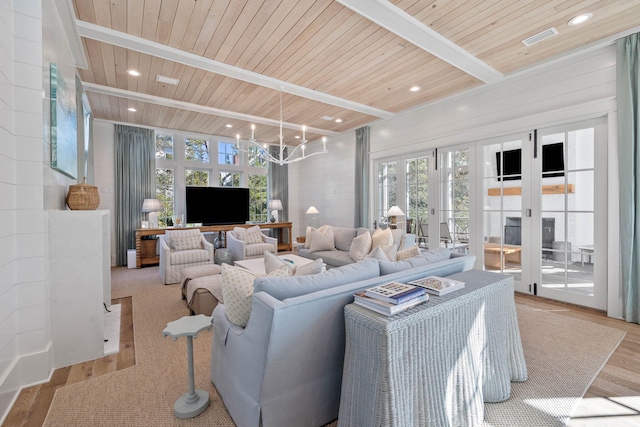 living room featuring a notable chandelier, light hardwood / wood-style floors, wooden ceiling, and a wealth of natural light