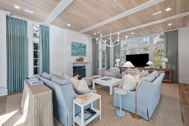 living room featuring hardwood / wood-style flooring, beam ceiling, wooden ceiling, and a chandelier