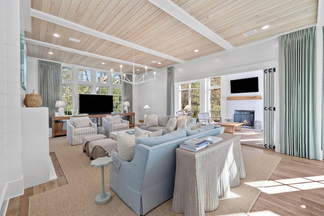 living room with beam ceiling, light hardwood / wood-style flooring, wood ceiling, and a notable chandelier