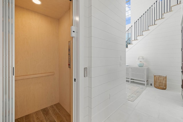 interior space featuring wood-type flooring and elevator