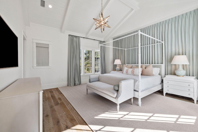 bedroom with lofted ceiling with beams, dark hardwood / wood-style flooring, and an inviting chandelier