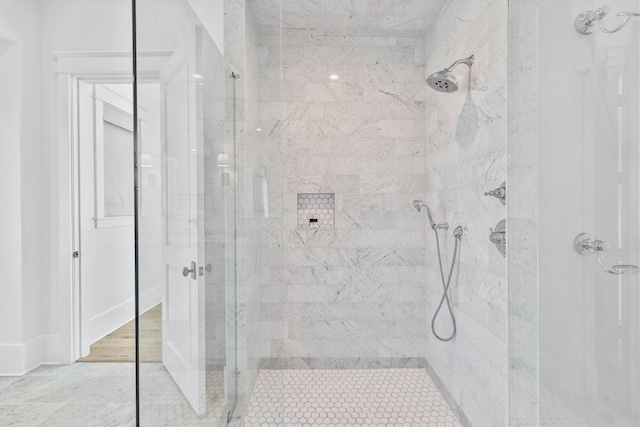 bathroom with a tile shower