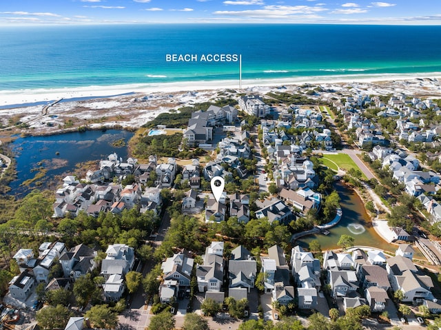 drone / aerial view featuring a beach view and a water view