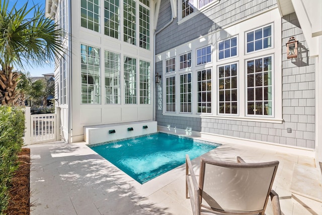 view of pool with pool water feature and a patio