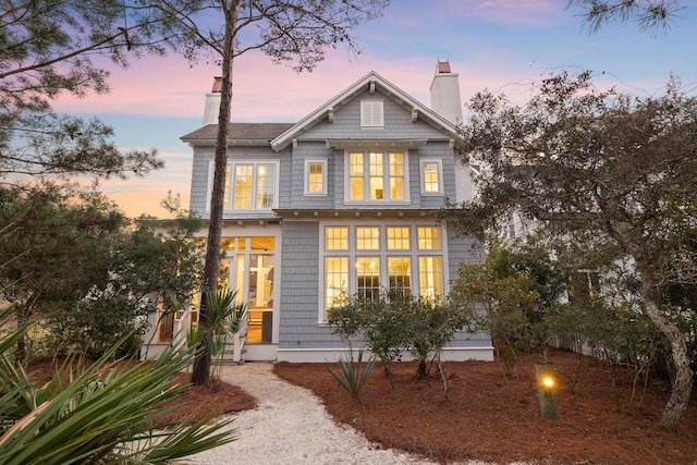 view of back house at dusk