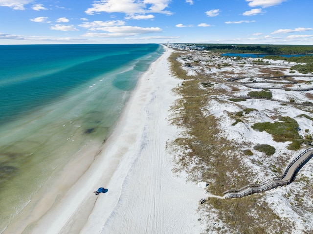 aerial view with a water view and a view of the beach