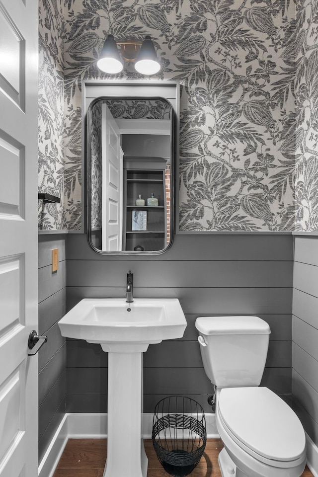 bathroom featuring hardwood / wood-style floors and toilet